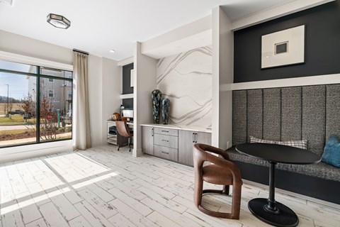 A modern living room with a wooden chair and a black table.