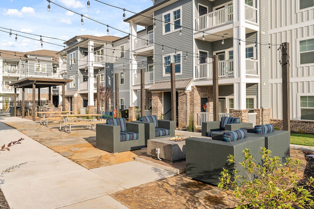 our apartments have an outdoor patio with furniture and tables