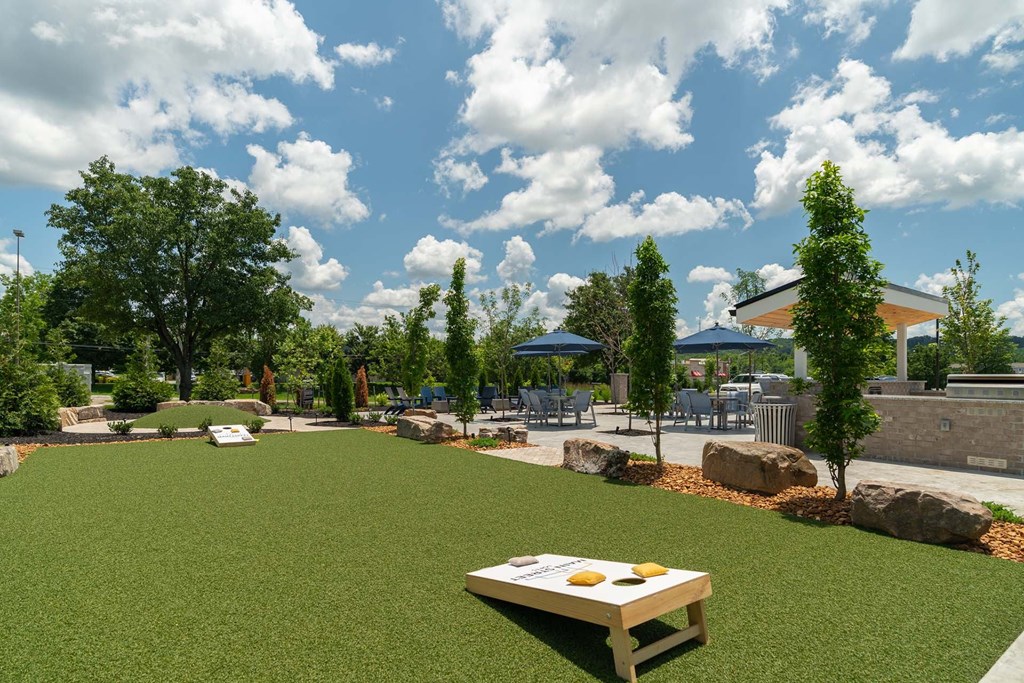 A picnic table is in the middle of a grassy area.