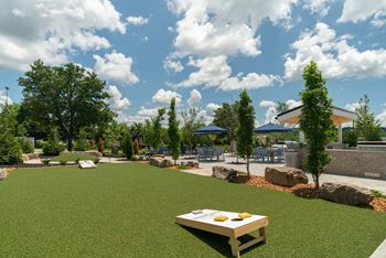 A picnic table is in the middle of a grassy area.