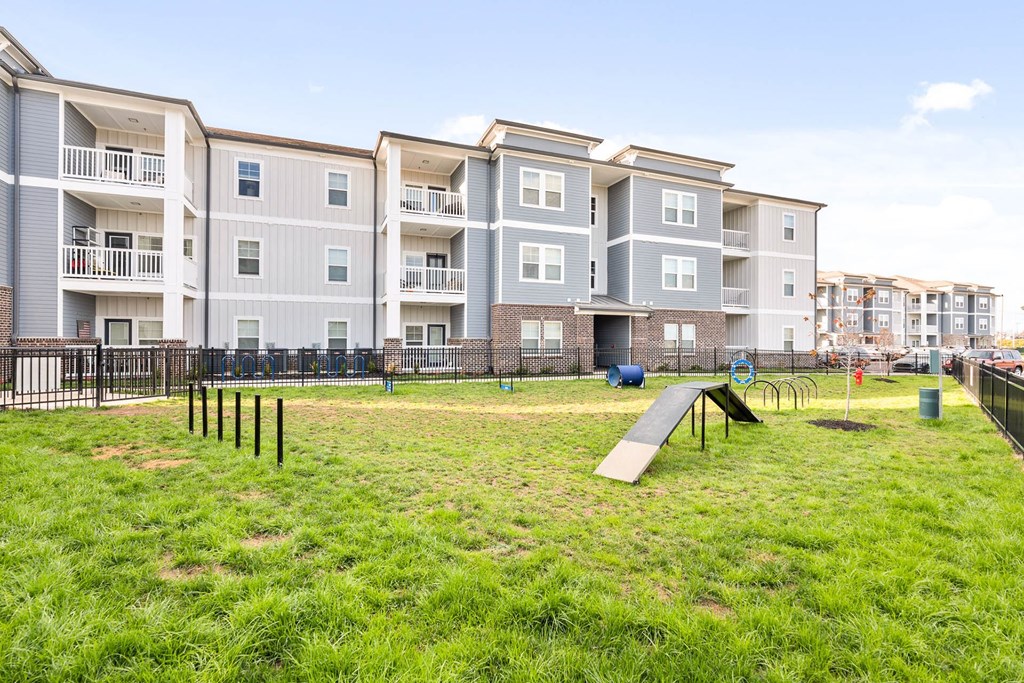 a park with a playground in front of an apartment building