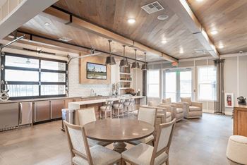 Clubroom with seating areas, computer workspaces, fireplace, and coffee bar and refreshments