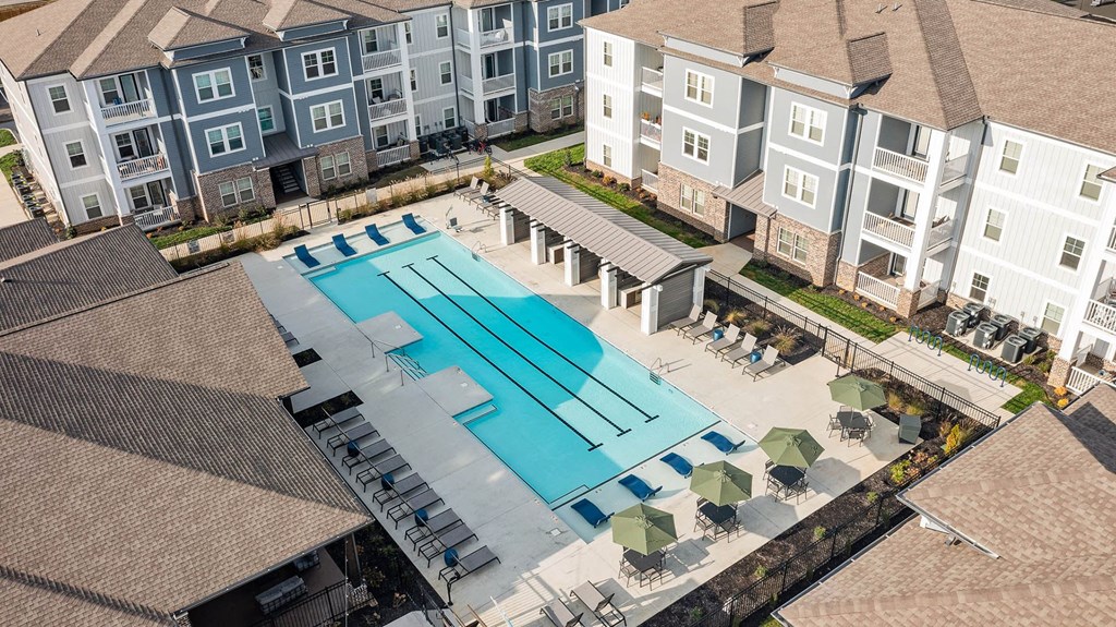 an aerial view of a swimming pool at an apartment building