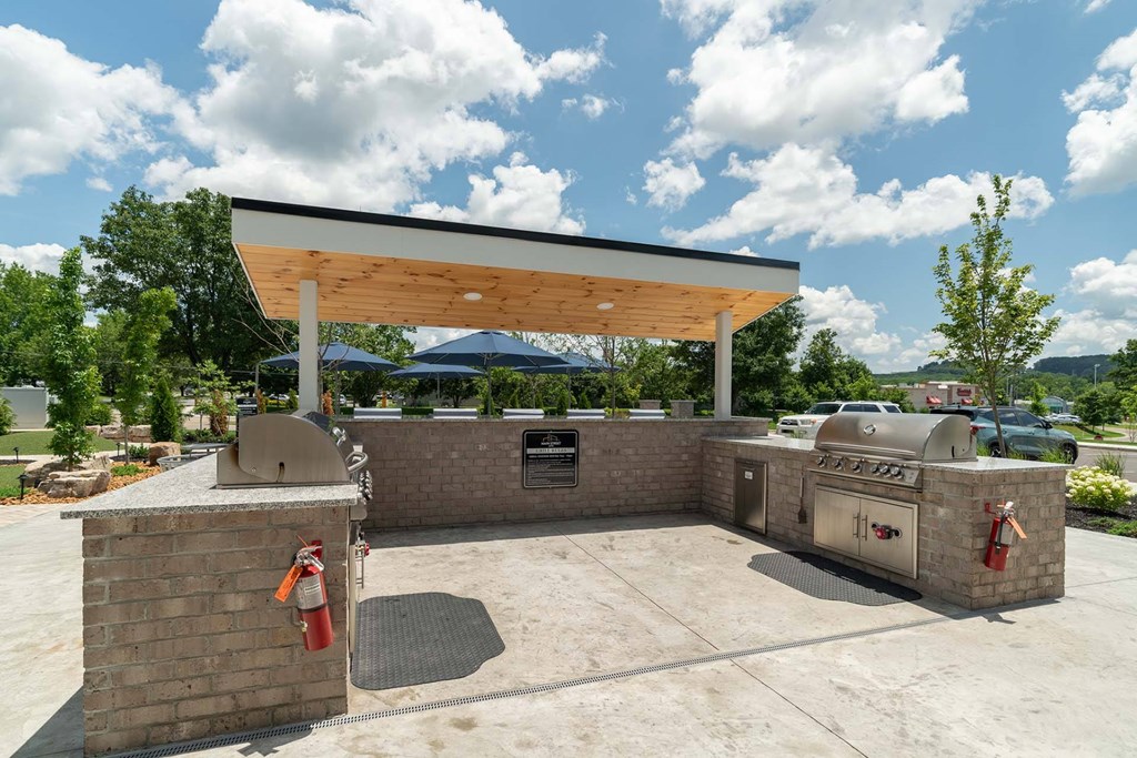 A covered outdoor area with a brick wall and a fire extinguisher.