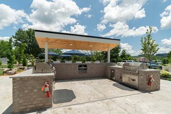 A covered outdoor area with a brick wall and a fire extinguisher.