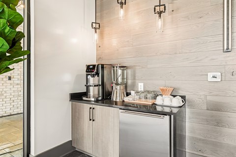 A modern kitchen with a stainless steel refrigerator and wooden cabinets.