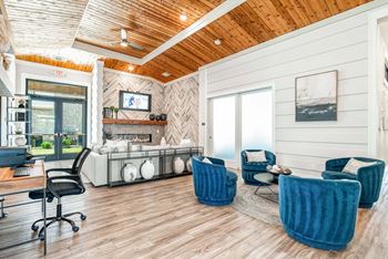 A room with a wooden ceiling and a fireplace with a TV above it.