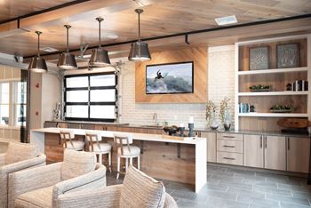 Clubroom with seating areas, computer workspaces, fireplace, and coffee bar and refreshments