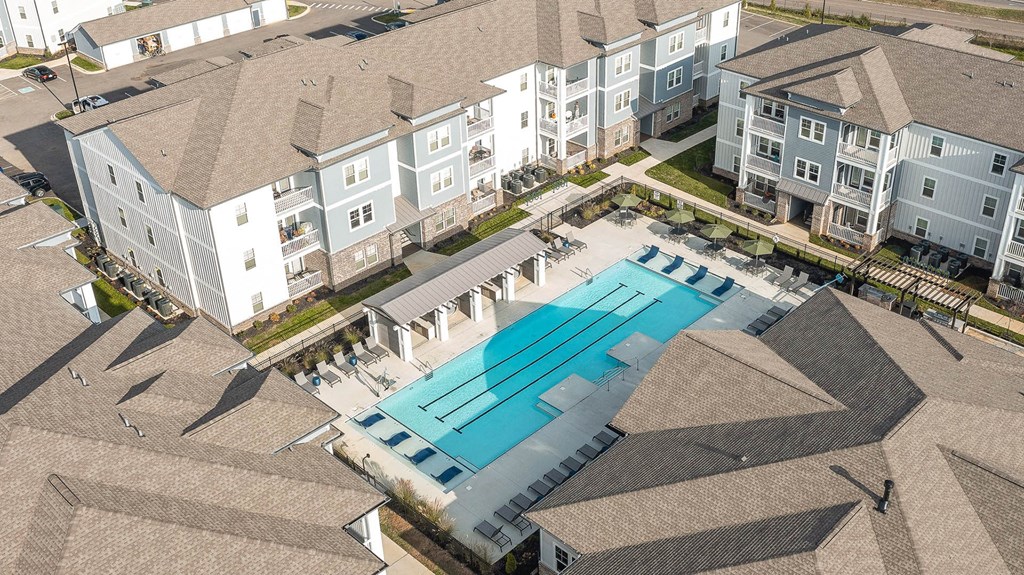 an aerial view of a swimming pool at an apartment building