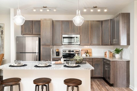 a kitchen with stainless steel appliances and wooden cabinets
