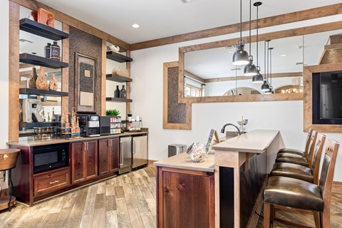 A kitchen with wooden cabinets and a large mirror on the wall.