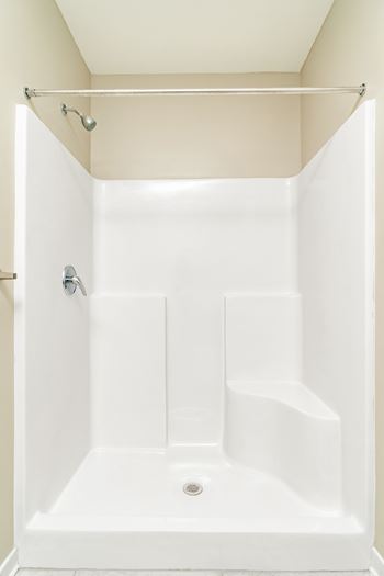 a small bathroom with a shower and a sink