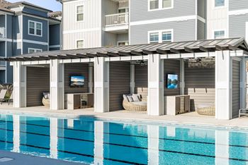 Sundeck with lounge chairs, tables, and chairs and four Private Cabanas each outfitted with daybed, minibar refrigerator and television