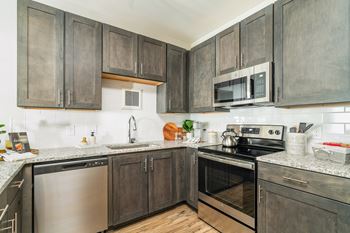 a kitchen with stainless steel appliances and wooden cabinets