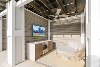 Sundeck with lounge chairs, tables, and chairs and four Private Cabanas each outfitted with daybed, minibar refrigerator and television