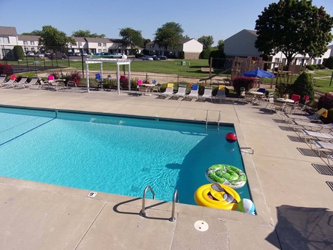 A swimming pool with a blue hose and a yellow float.