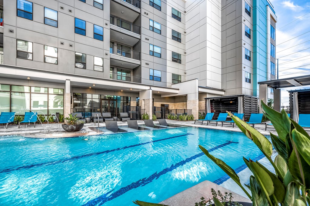 a large swimming pool with a building in the background
