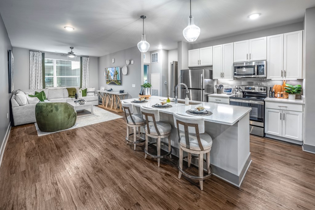 an open kitchen and living room with a large center island