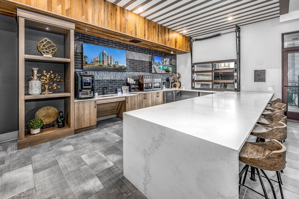 the kitchen has a large island with a marble counter top