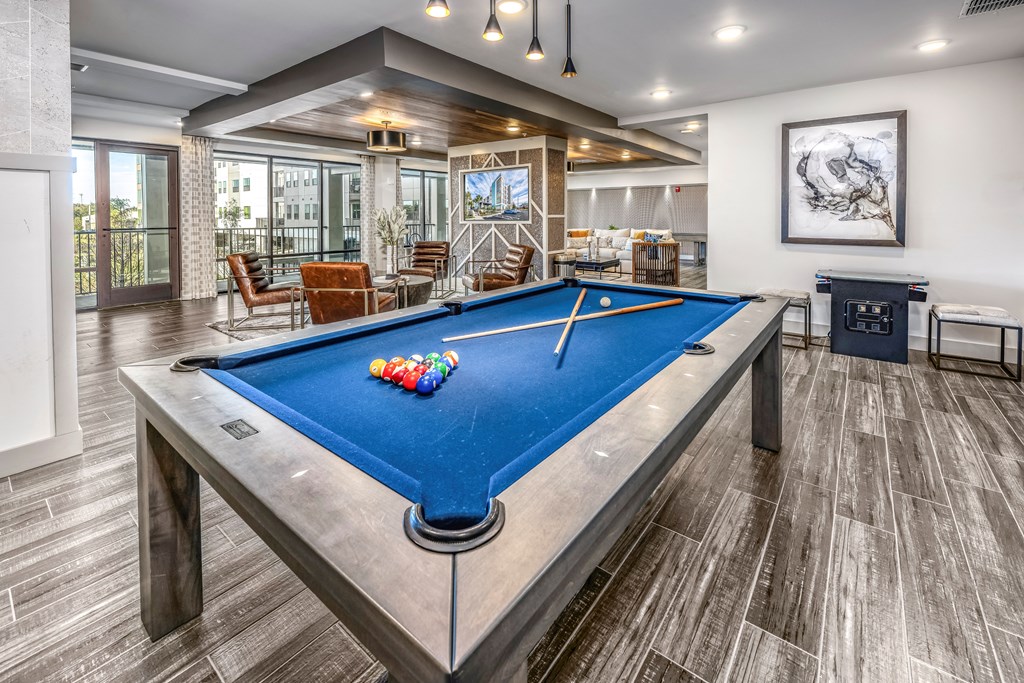 a billiards table in a clubhouse with a blue pool table
