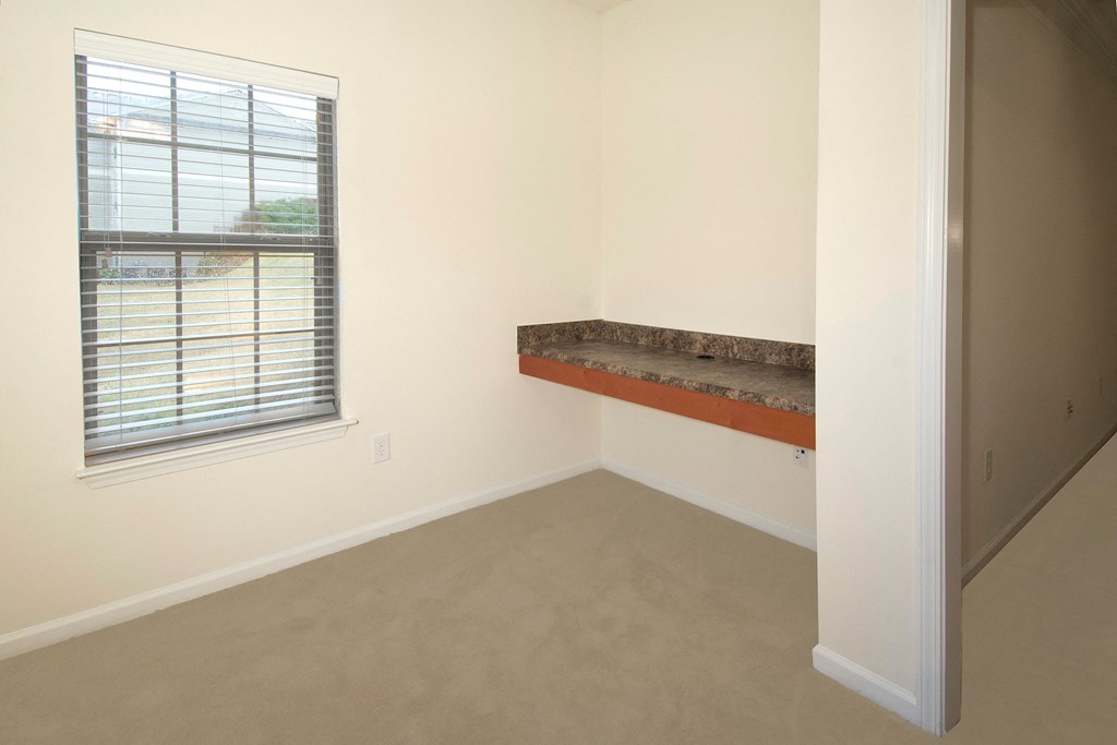 an empty room with a window and a counter