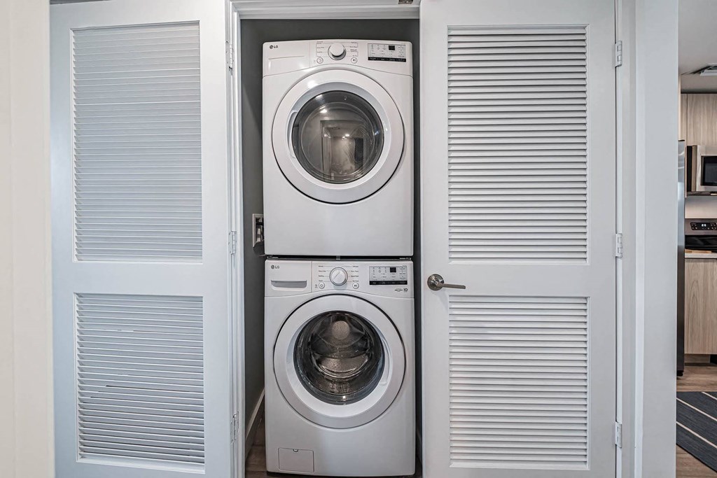 a small laundry room with a washing machine and a dryer at Altis Blue Lake, Lake Worth, FL, 33467