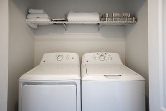 a small laundry room with two washes and a dryer