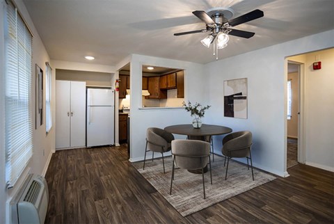 A dining room with a table and chairs.