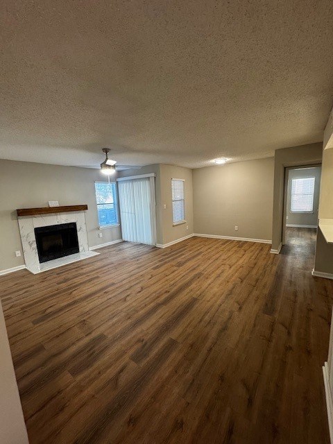 A room with a fireplace and wood flooring.