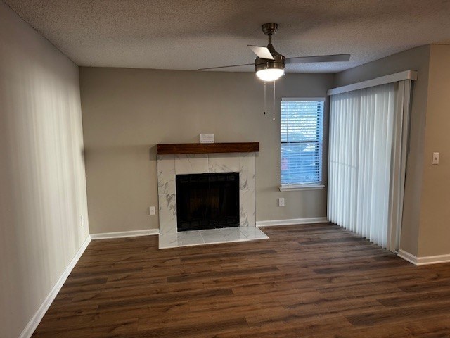 A living room with a fireplace and wood flooring.