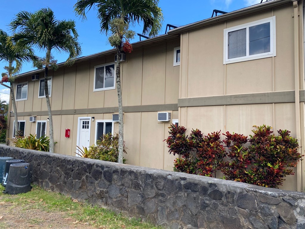 a building with a stone wall in front of it