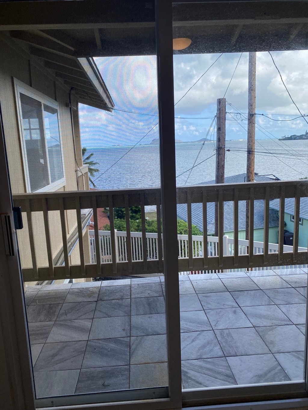 a view of the ocean from the porch of a house