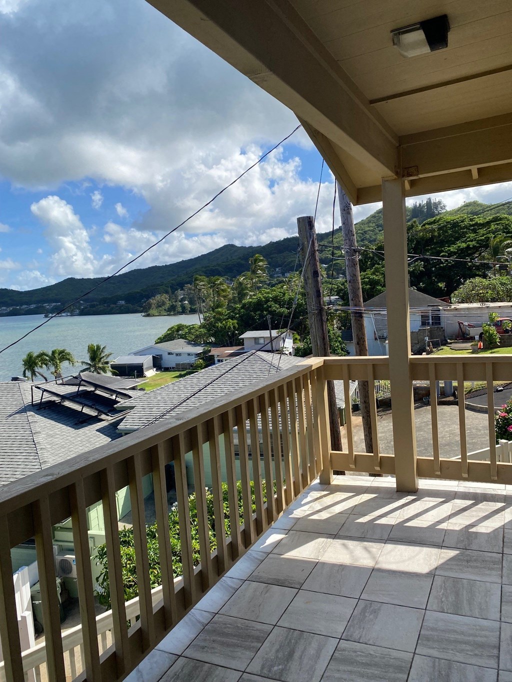 the view from the deck of a house overlooking the water and a dock