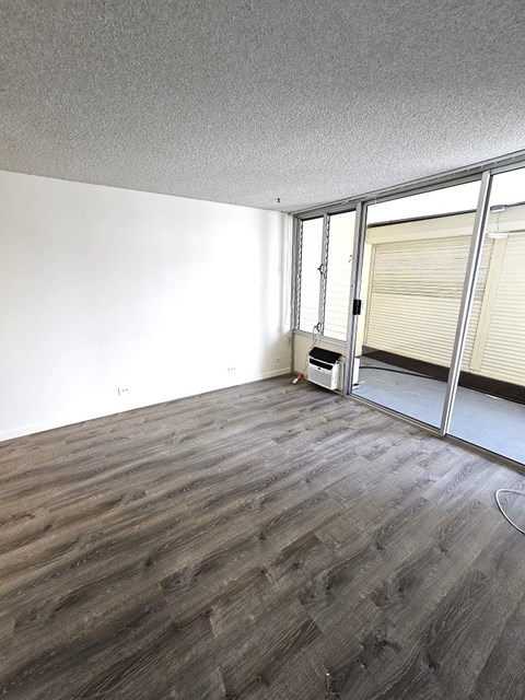 an empty living room with a sliding glass door