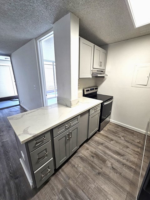 a kitchen with white cabinets and a white counter top