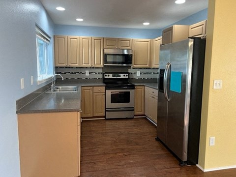 A kitchen with a refrigerator on the right.
