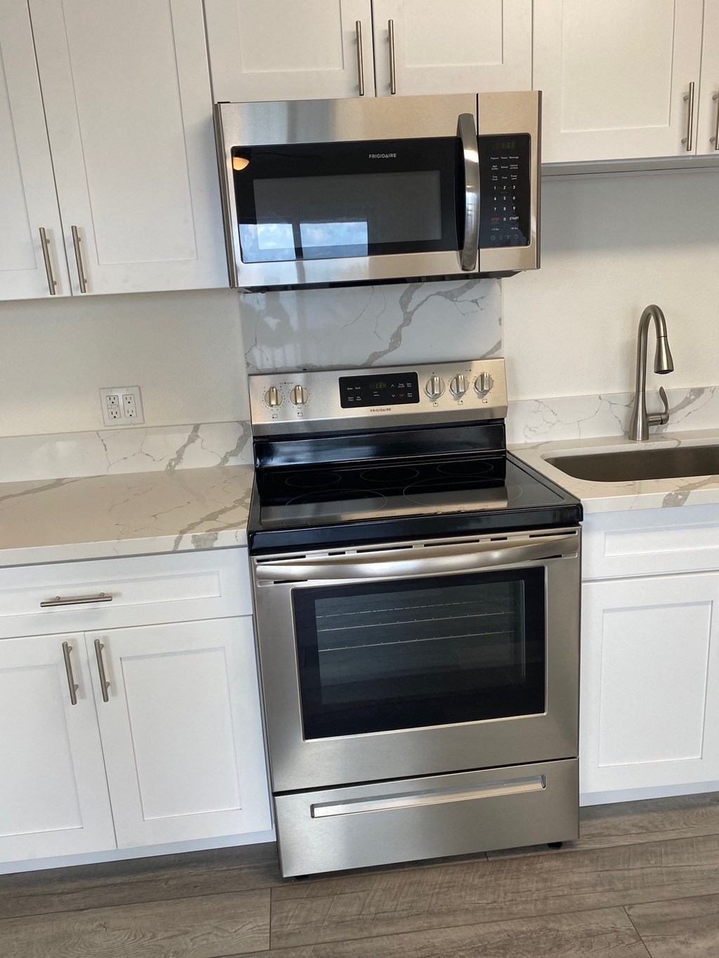 a kitchen with stainless steel appliances and white cabinets