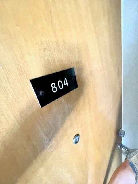 a wooden door with the number 804 on it