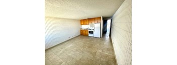 a kitchen with a white stove top oven next to a refrigerator