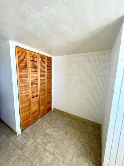 a small room with a tile floor and wooden doors