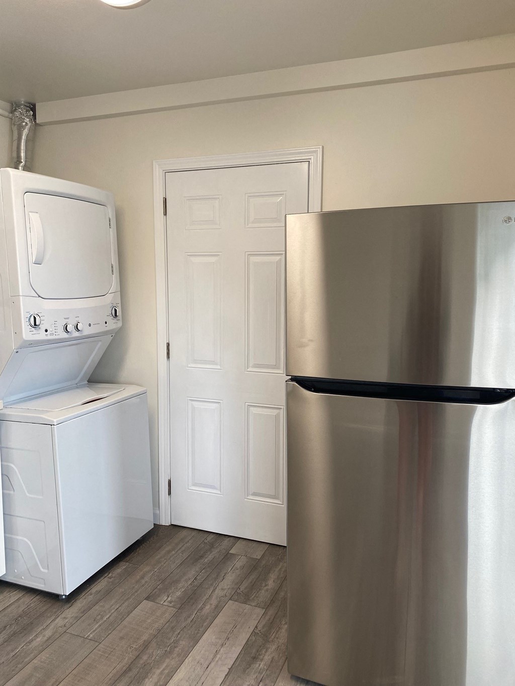 a kitchen with a refrigerator and a washer and dryer