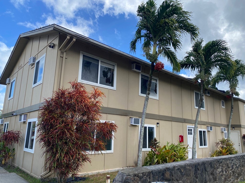 a house with palm trees in front of it