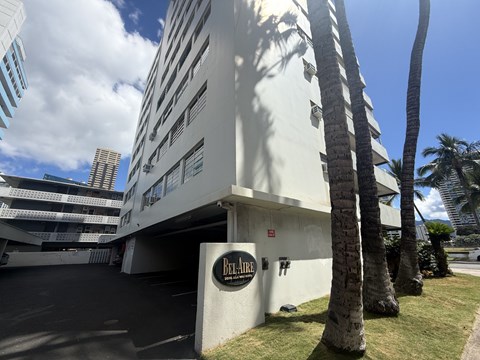 A white building with a sign that says Bel-Air.