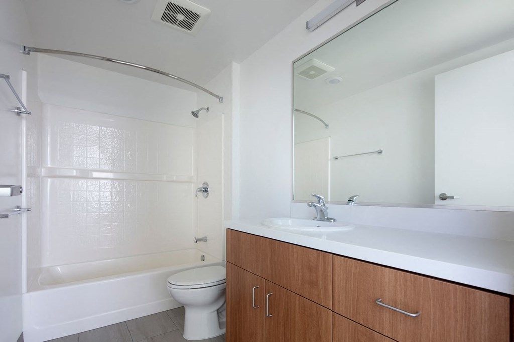 a bathroom with a sink toilet and a mirror
