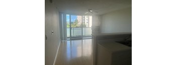 an empty kitchen with a large window and a balcony