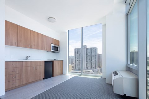 a kitchen with a large window and a city view