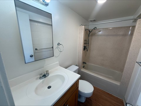 A white sink with a mirror above it in a bathroom.