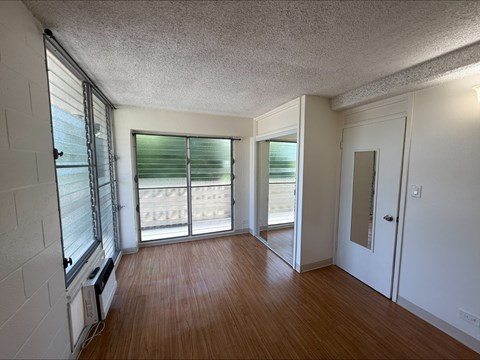 A room with wooden floors and white walls.