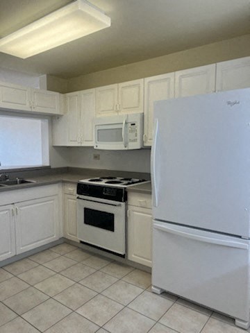 a kitchen with white appliances and white cabinets