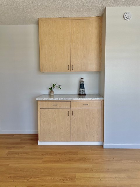 A kitchen with wooden cabinets and a white fridge.